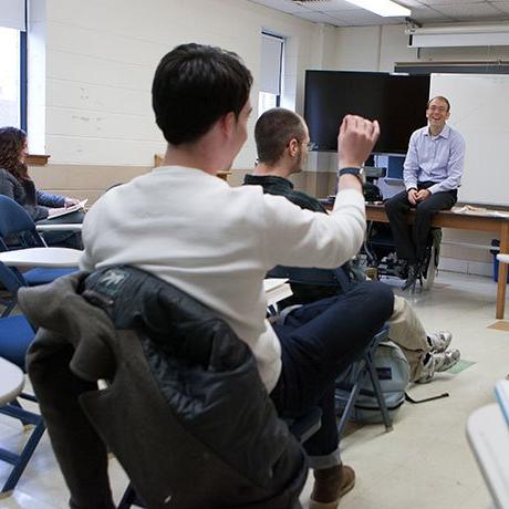 Student raising hand in class