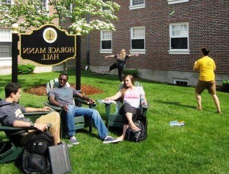 friends sitting in Adirondack chairs outside of Horace Mann